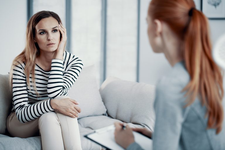 two woman are talking to each other